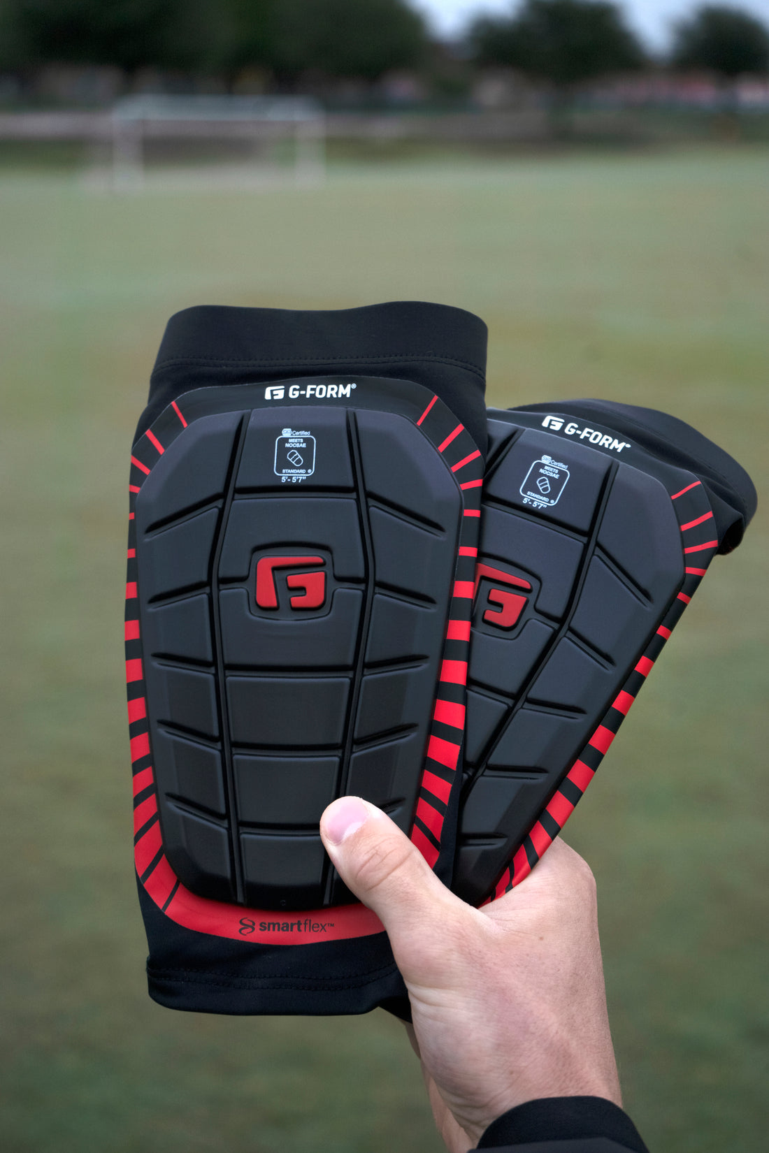football shin guards in hands